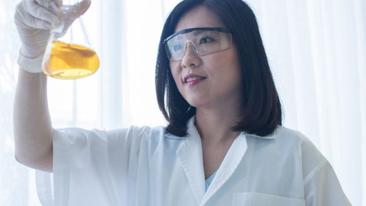 female chemist with bisabolol in lab