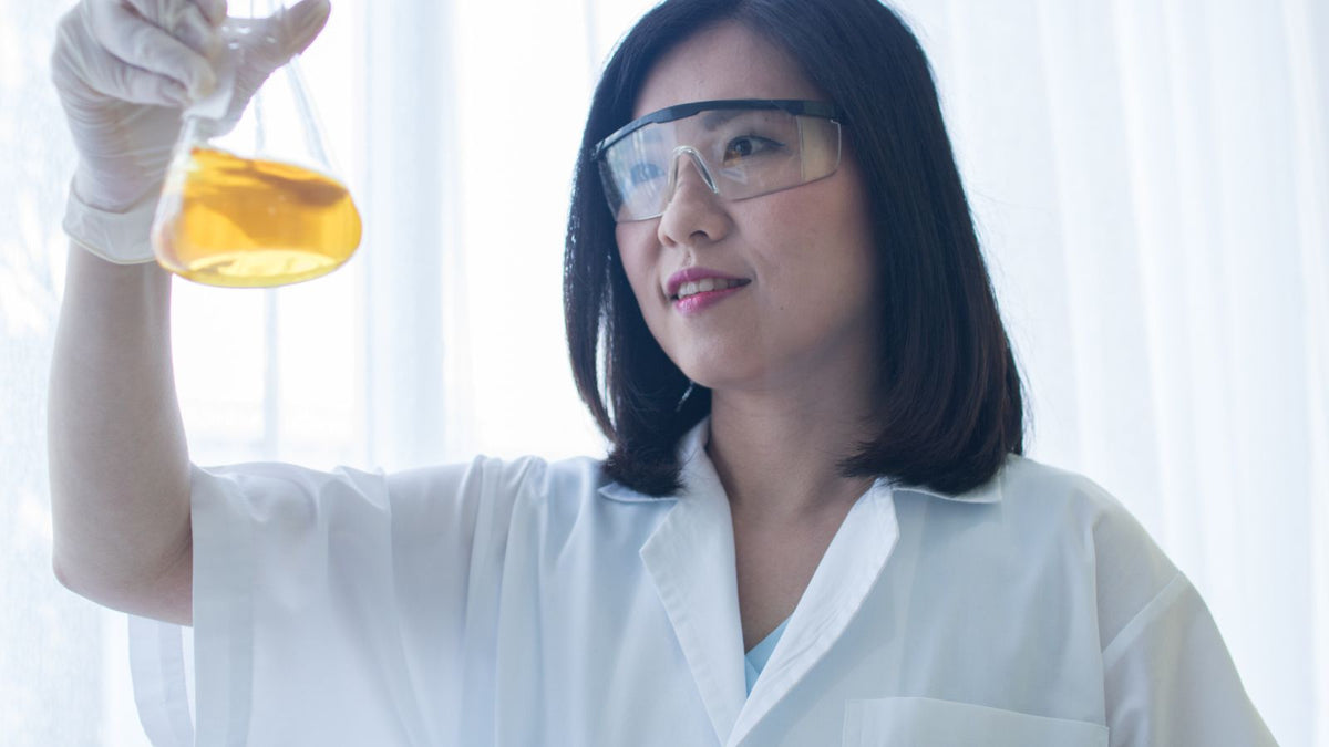 female chemist with bisabolol in lab