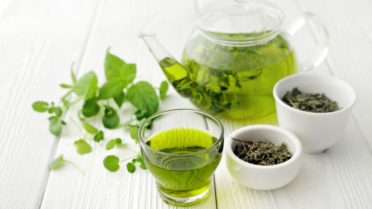 Green tea and green tea leaves on a table