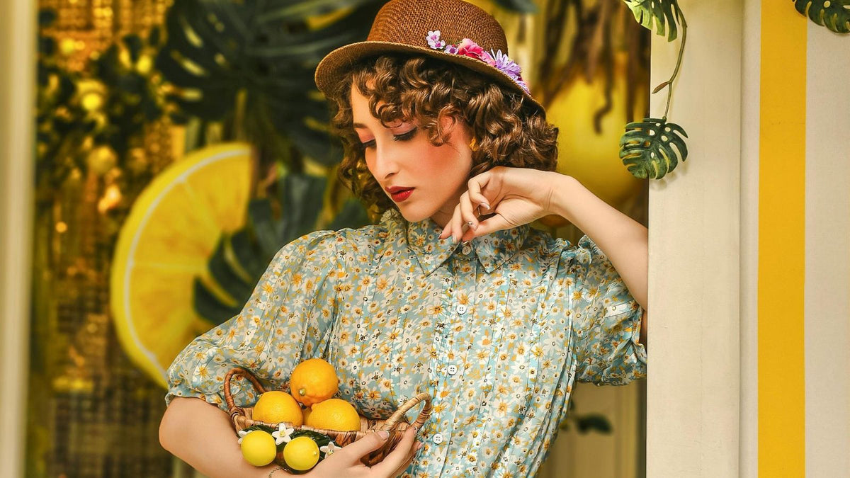 woman looking at a basket of lemons