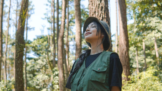 woman happily smelling pine forest