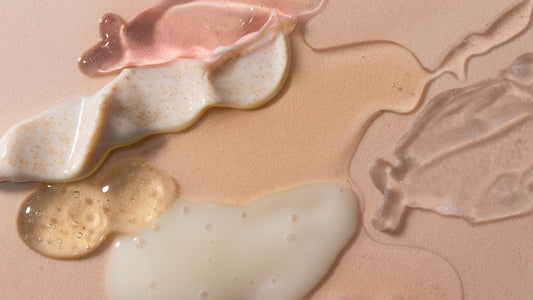 different skincare products on a rose cream background