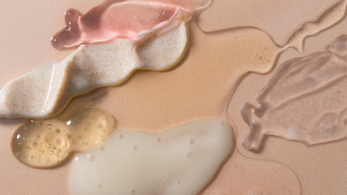 different skincare products on a rose cream background
