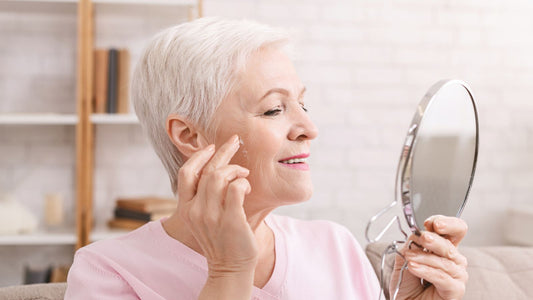 older woman looking at herself in mirror