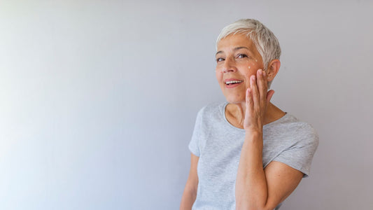 woman putting cream near her eyes