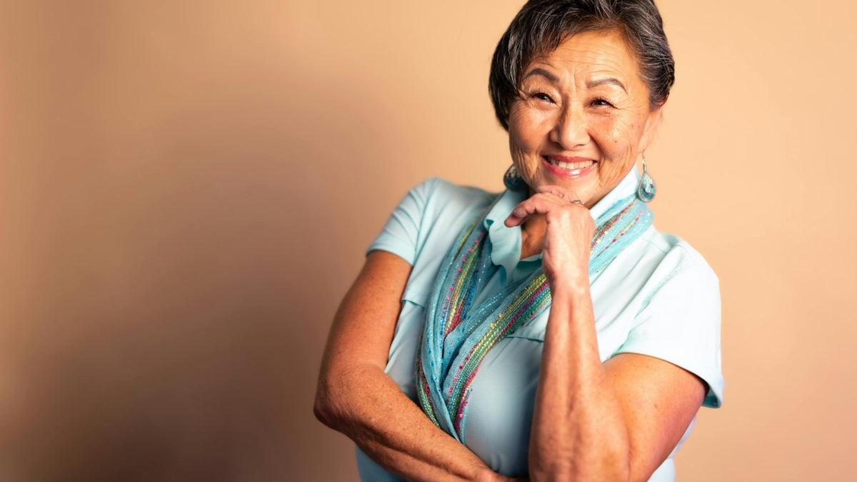 older asian woman smiling at camera