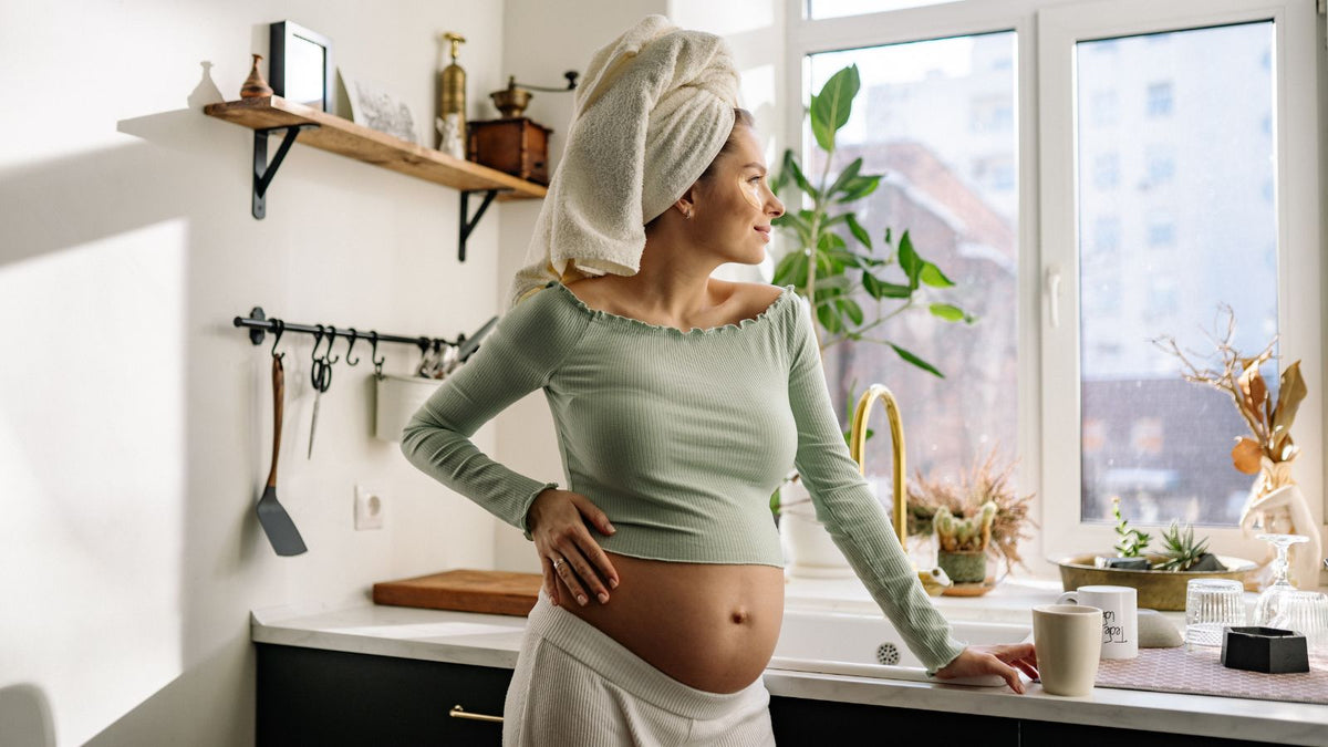 pregnant woman with skincare products