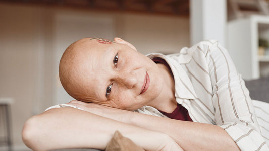 a chemo patient with her arm and head on the table