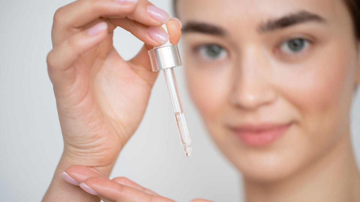 woman holding dropper of allantoin