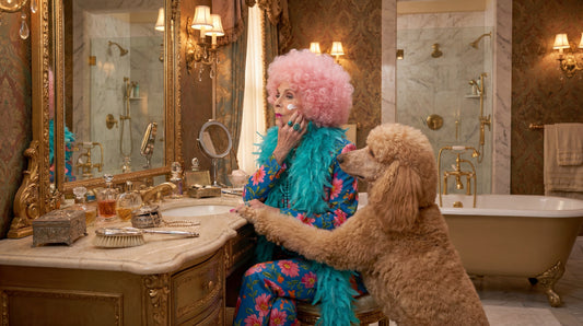 Pink Haired Betty is putting on the nighttime face make routine in her bathroom with her dog