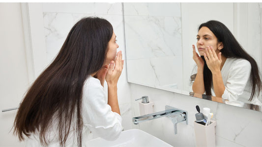 woman putting on face cream  in the am